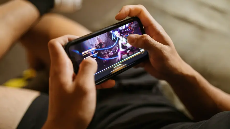 Person holding an Android phone while gaming